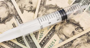 Syringe on a twenty dollar bills background