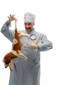 Roger Biduk - Vaccinations vet holding dog by tail